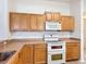 Kitchen with a double oven, wood cabinets, and ample counter space at 4908 Cape Hatteras Dr, Clermont, FL 34714