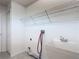 Functional laundry room equipped with a utility sink, ample shelving, and neutral wall creating a clean space at 4908 Cape Hatteras Dr, Clermont, FL 34714