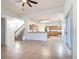 A spacious living room featuring tile floors with an open floor plan, flowing to the kitchen and stairs at 4908 Cape Hatteras Dr, Clermont, FL 34714