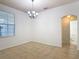 Open living room with a view of the bathroom and a large window for natural light at 4908 Cape Hatteras Dr, Clermont, FL 34714