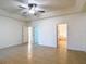 Spacious main bedroom with a ceiling fan, neutral paint, and tile flooring, creating a relaxing retreat at 4908 Cape Hatteras Dr, Clermont, FL 34714