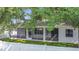 A view of the screened-in patio and partial backyard with a white privacy fence at 4908 Cape Hatteras Dr, Clermont, FL 34714