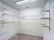 Walk-in closet with wire shelving and laminate wood flooring at 4908 Cape Hatteras Dr, Clermont, FL 34714