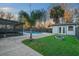 Private backyard featuring a pool, screened in patio, storage shed, fire pit, and mature landscaping at 5011 Se 33Rd Ave, Ocala, FL 34480