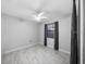 Bright bedroom featuring new flooring, neutral paint, a ceiling fan, and a window with privacy blinds at 5011 Se 33Rd Ave, Ocala, FL 34480