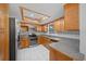 Well-lit kitchen featuring stainless steel appliances, generous countertop space, and wood cabinets at 5011 Se 33Rd Ave, Ocala, FL 34480