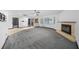 Spacious living room with new carpeting, fireplace, and large windows with plenty of natural light at 5011 Se 33Rd Ave, Ocala, FL 34480