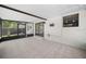 Enclosed patio featuring tile flooring, a screen, and sliding glass doors to the backyard at 5011 Se 33Rd Ave, Ocala, FL 34480