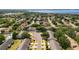 Beautiful aerial shot of a neighborhood highlighting tree-lined streets, well-maintained homes, and a serene lake in the background at 520 Rob Roy Dr, Clermont, FL 34711