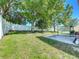 Spacious fenced in backyard features a manicured lawn and covered patio space at 520 Rob Roy Dr, Clermont, FL 34711