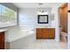 Bright bathroom features a soaking tub with tile surround, vanity with storage, and white tile flooring at 520 Rob Roy Dr, Clermont, FL 34711