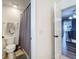 Small bathroom featuring a toilet, grey shower curtain, tile floors, and a light switch by the doorway at 520 Rob Roy Dr, Clermont, FL 34711