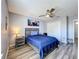 Bedroom featuring wood-look floors, a ceiling fan, natural light, and gray wood bedroom furniture at 520 Rob Roy Dr, Clermont, FL 34711