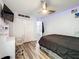 This bedroom features wood-look floors, a desk and chair, a ceiling fan, and a closet for ample storage at 520 Rob Roy Dr, Clermont, FL 34711