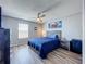 This bedroom has wood-look floors, a ceiling fan, natural light, and gray wood furniture set at 520 Rob Roy Dr, Clermont, FL 34711