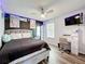 Bedroom featuring wood-look floors and neon decor at 520 Rob Roy Dr, Clermont, FL 34711