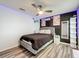 Stylish bedroom features wood-look floors, neon decor, and a ceiling fan at 520 Rob Roy Dr, Clermont, FL 34711