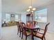 Well-lit dining room connected to the living area, showcasing a wooden table and ample space for entertaining at 520 Rob Roy Dr, Clermont, FL 34711