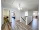 Bright hallway with wood-look floors and open access to the bedrooms at 520 Rob Roy Dr, Clermont, FL 34711