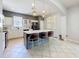 Modern kitchen featuring a center island with seating, stylish pendant lighting and stainless steel appliances at 520 Rob Roy Dr, Clermont, FL 34711