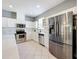 Modern kitchen featuring stainless steel appliances, white cabinetry, and stylish backsplash at 520 Rob Roy Dr, Clermont, FL 34711