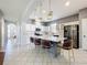 Bright eat-in kitchen boasts a large center island with seating, modern lighting, and stainless appliances at 520 Rob Roy Dr, Clermont, FL 34711