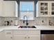 Bright kitchen showcasing a stainless steel sink with designer faucet and herringbone tile backsplash at 520 Rob Roy Dr, Clermont, FL 34711