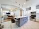 Updated kitchen with a center island, pendant lights, and a seamless flow into the adjoining living area at 520 Rob Roy Dr, Clermont, FL 34711