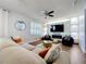 Inviting living room with comfortable seating, ceiling fan, and a sleek entertainment center at 520 Rob Roy Dr, Clermont, FL 34711