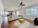 Open-concept living area with contemporary furnishings, wood flooring, and a view of the kitchen at 520 Rob Roy Dr, Clermont, FL 34711