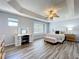 Primary bedroom with wood-look floors, a trey ceiling, ceiling fan, and vanity area at 520 Rob Roy Dr, Clermont, FL 34711