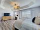 Primary bedroom features wood-look floors, a trey ceiling, ceiling fan, and plenty of natural light at 520 Rob Roy Dr, Clermont, FL 34711