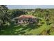 Aerial view of a home with a screened-in pool, surrounded by lush greenery at 5495 County Road 125, Wildwood, FL 34785