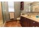Relaxing bathroom featuring shower, toilet, and vanity with drawers and large mirror at 5495 County Road 125, Wildwood, FL 34785