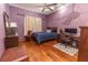 A bedroom offers a bed, study space, and hardwood floors for a comfortable atmosphere at 5495 County Road 125, Wildwood, FL 34785