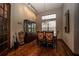 Charming dining room is beautifully appointed with hardwood floors, a chandelier, and custom shelving at 5495 County Road 125, Wildwood, FL 34785