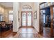 Inviting foyer features a decorative front door with tile flooring and natural light, complemented by wood floors at 5495 County Road 125, Wildwood, FL 34785
