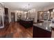 An expansive kitchen with dark wood cabinetry, granite countertops, and modern lighting fixtures at 5495 County Road 125, Wildwood, FL 34785