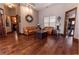 This living room features hardwood floors and comfortable leather sofas at 5495 County Road 125, Wildwood, FL 34785