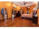 Comfortable main bedroom showcases hardwood floors, tray ceiling, a decorative mirror, and ample closet space at 5495 County Road 125, Wildwood, FL 34785