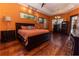 Spacious main bedroom boasts hardwood floors, a tray ceiling, and ample natural light, creating a tranquil retreat at 5495 County Road 125, Wildwood, FL 34785