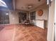 Covered outdoor patio with tile flooring, seating, and an outdoor kitchen at 5495 County Road 125, Wildwood, FL 34785