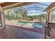 Screened in pool with a view of the backyard at 5495 County Road 125, Wildwood, FL 34785