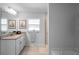 Well-lit bathroom featuring a granite vanity, framed mirrors, and a glass enclosed shower at 5890 Sw 83Rd St, Ocala, FL 34476