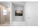 Clean bathroom featuring soaking tub, glass enclosed shower with tile surround and modern fixtures, plus a decorative photo at 5890 Sw 83Rd St, Ocala, FL 34476