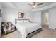 Bright bedroom featuring a king bed, cowhide chair, and tray ceiling at 5890 Sw 83Rd St, Ocala, FL 34476