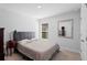 Neutral bedroom with a plush bed, side table and mirror at 5890 Sw 83Rd St, Ocala, FL 34476