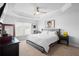 Spacious bedroom featuring tray ceilings, a ceiling fan, a king bed, and a window at 5890 Sw 83Rd St, Ocala, FL 34476
