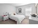 Simple bedroom with a window, light colored carpet, ceiling fan, and stylish decorations at 5890 Sw 83Rd St, Ocala, FL 34476