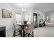 Bright dining area with stylish table, wood floors, and seamless access to kitchen at 5890 Sw 83Rd St, Ocala, FL 34476
